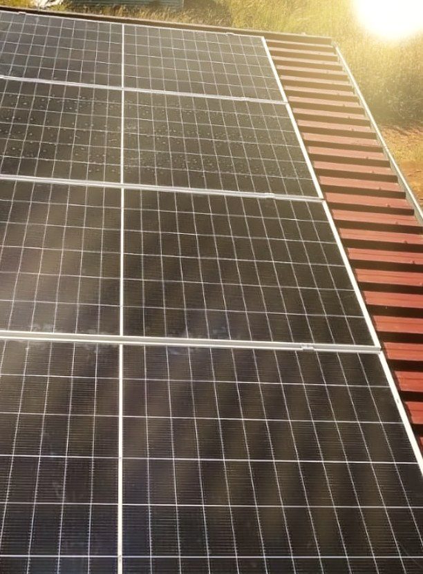 Solar panels on a tiled roof in full sun